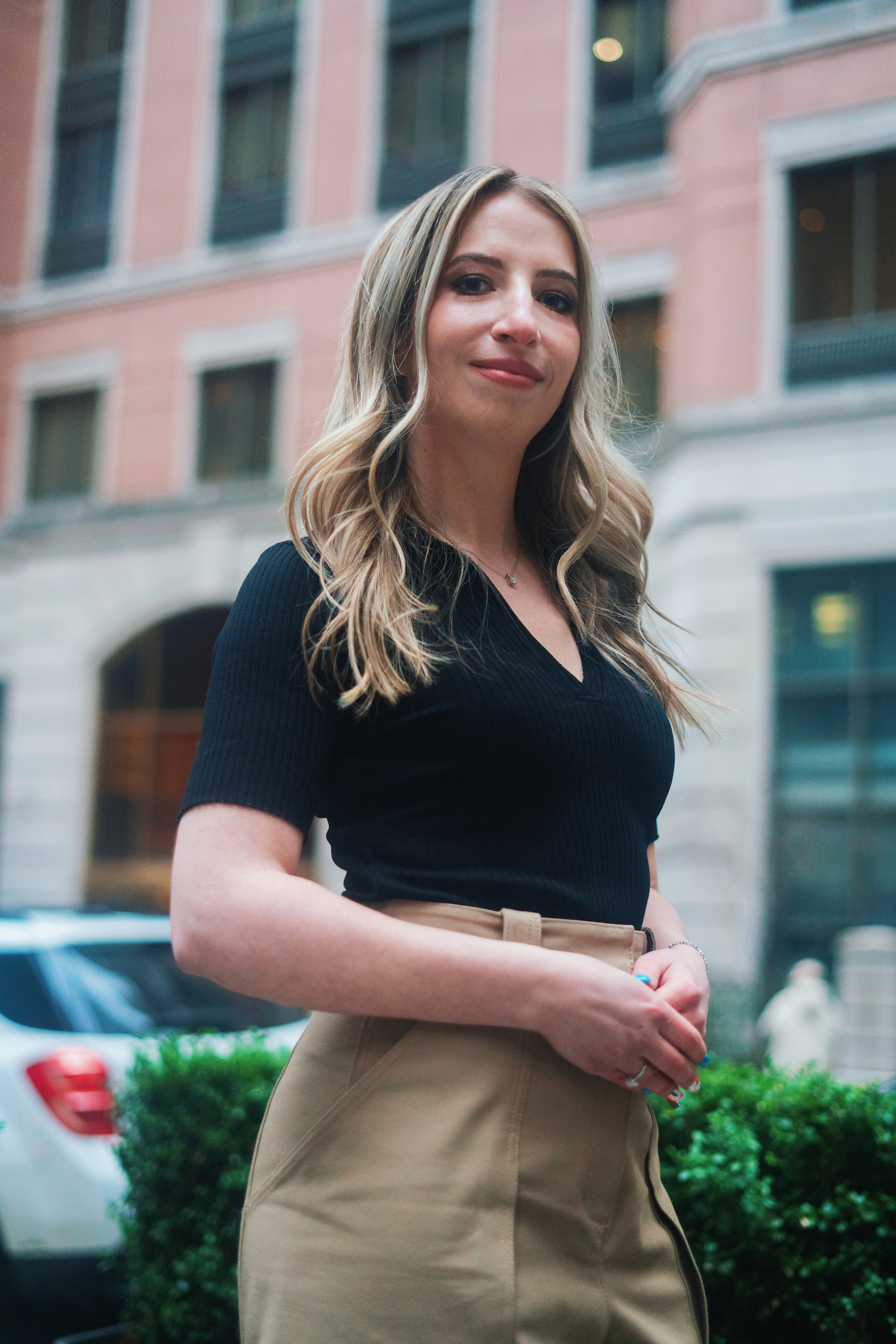 Author Peggy standing outside in front of an urban building