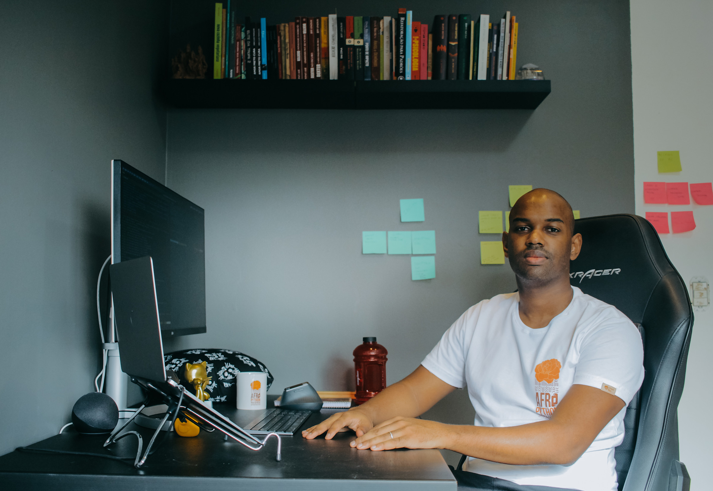 Author Felipe sitting in his office full of post-its and books