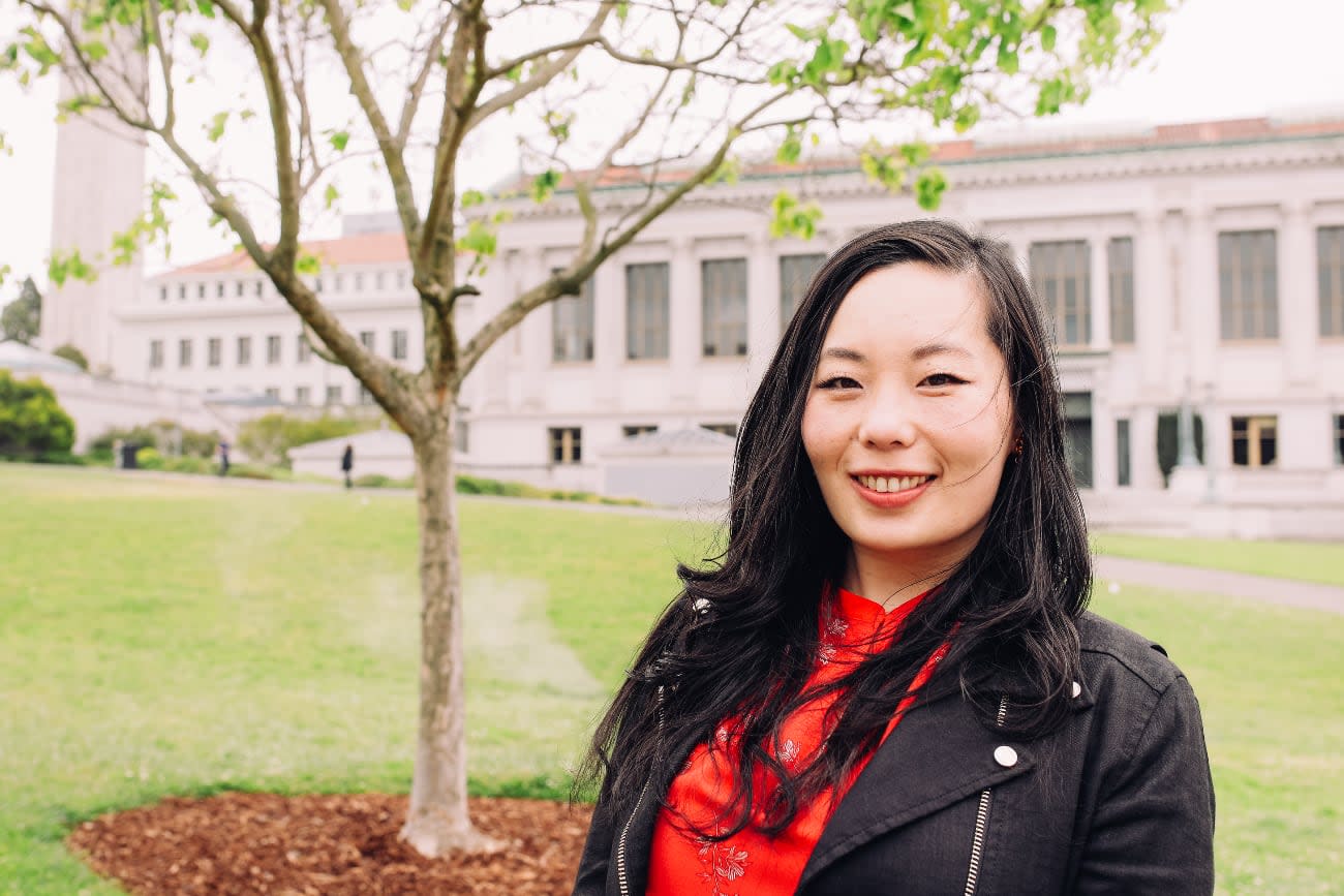 Photo of Shirley Wu posing in a park, gently smiling.