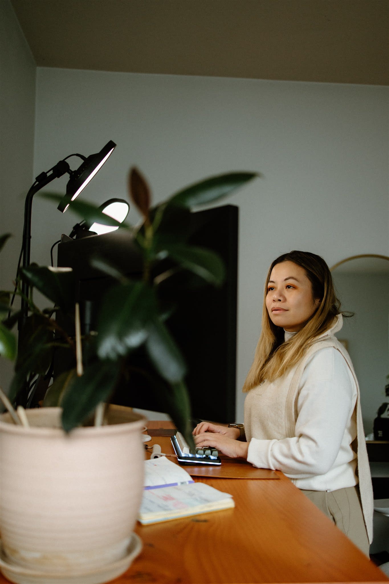 Author Tatiana sitting at her desk working on her computer