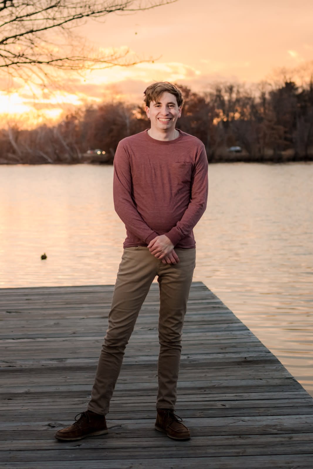 Author Jonathan standing on a dock while the sun sets behind him