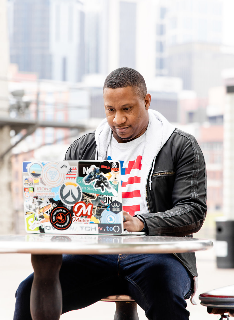 Photo of Jerome Hardaway working at a table in a park.