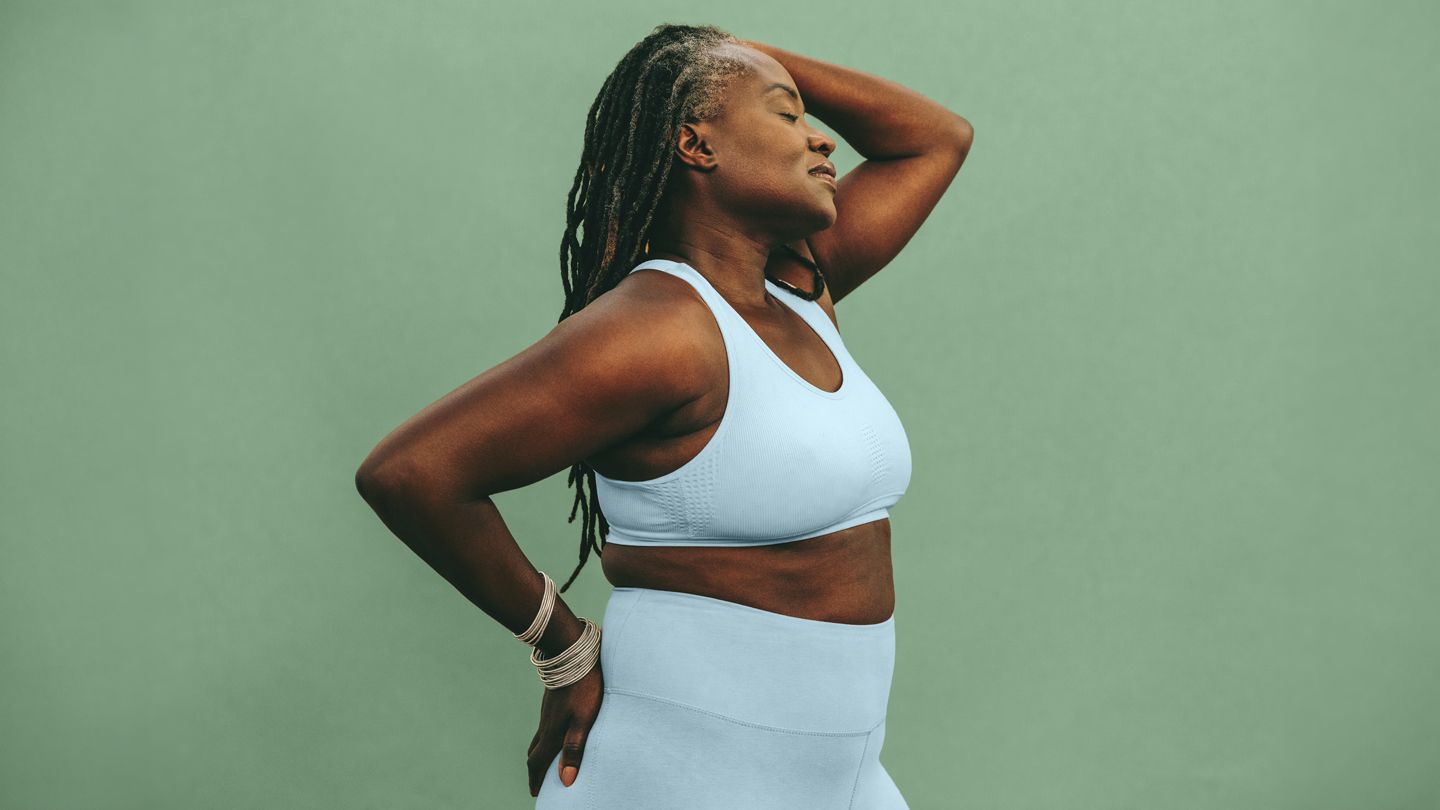 mature Black woman eyes closed in sportswear