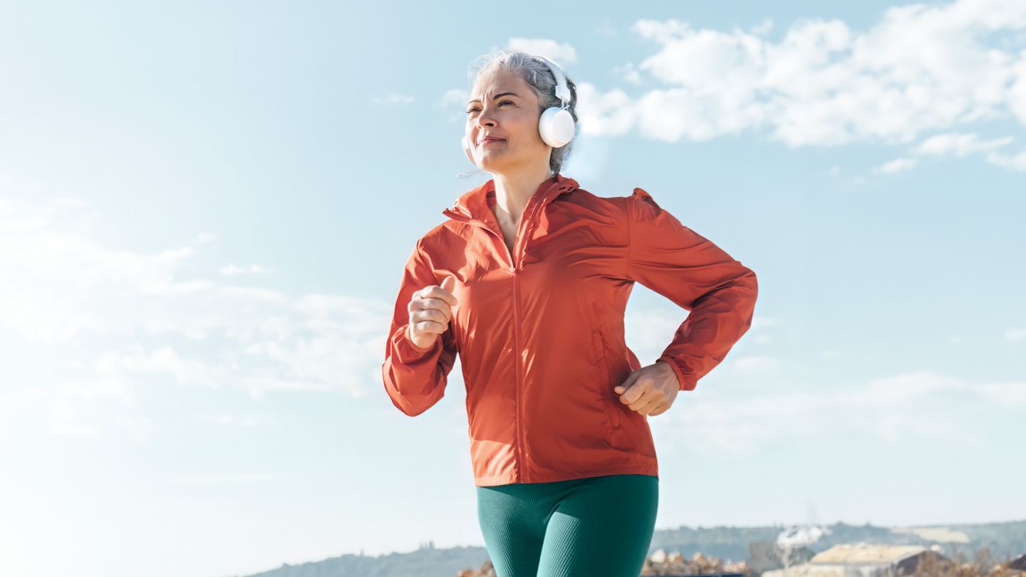 woman running outside with headphones