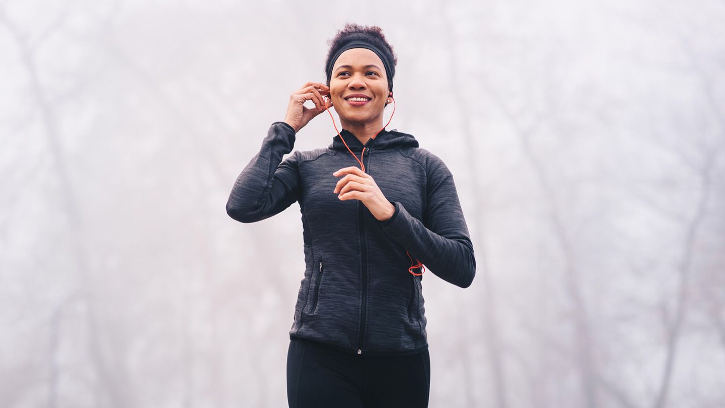 woman jogging in winter with ears covered