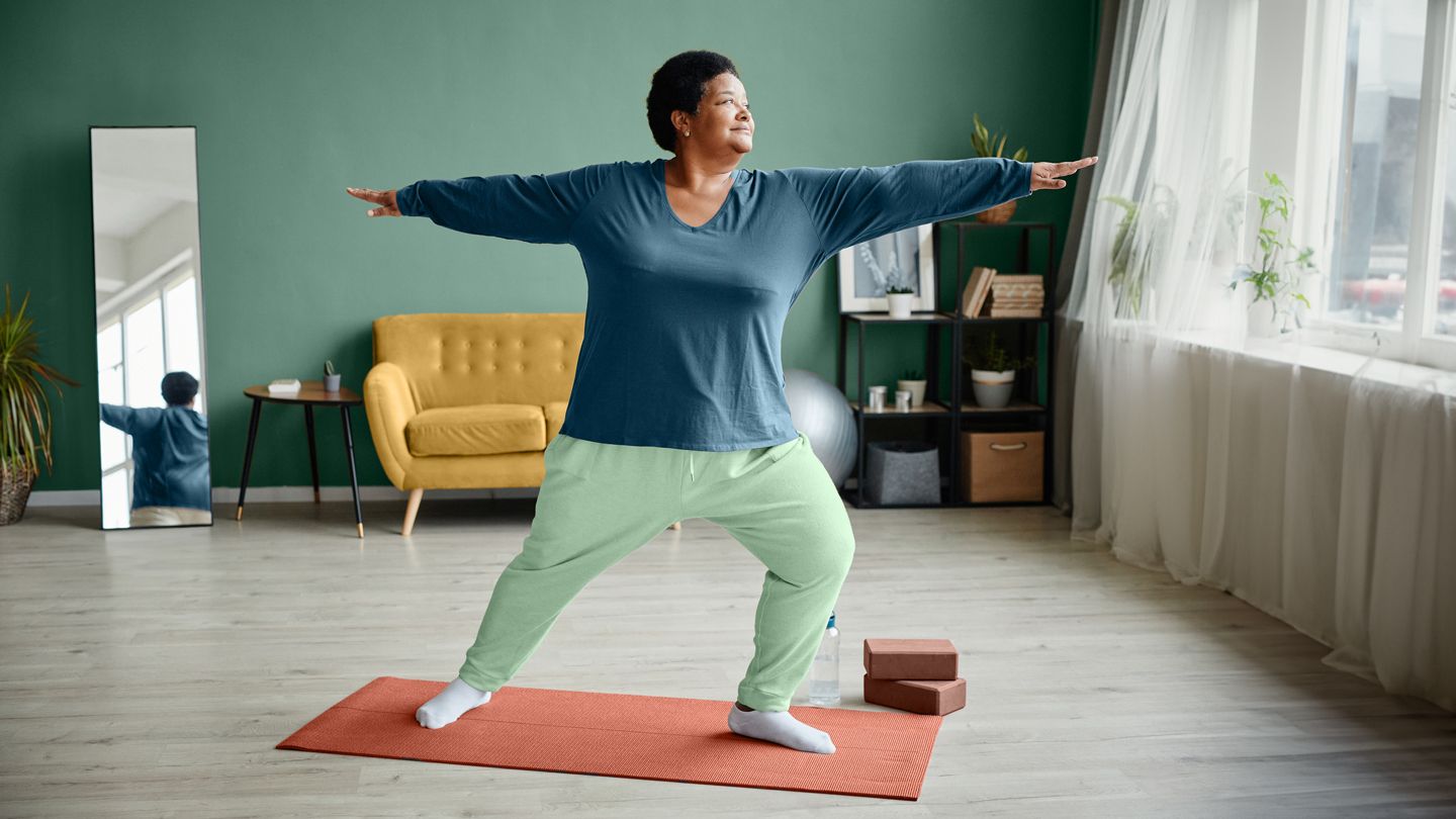 middle-aged Black woman doing yoga