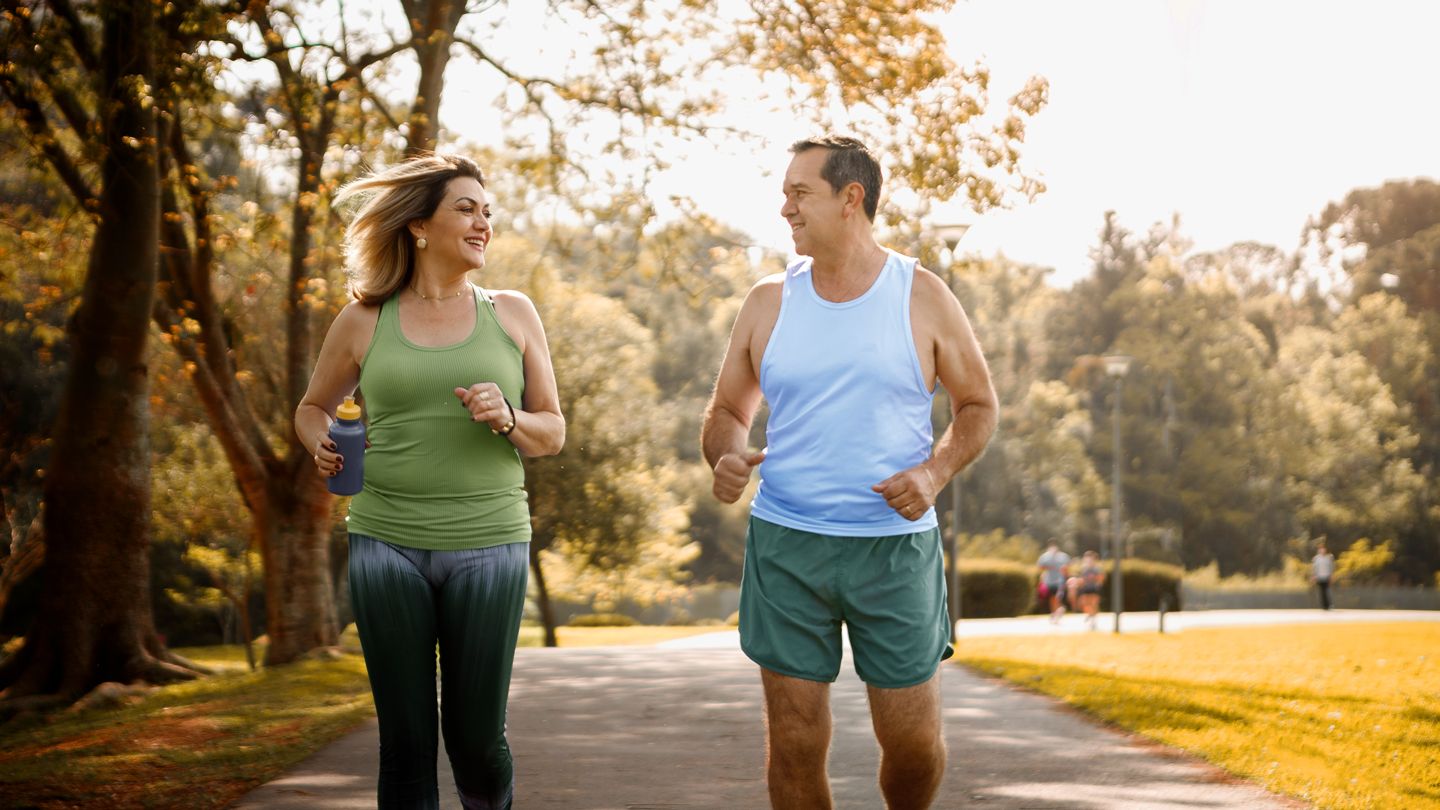 mature man and woman jogging in the evening