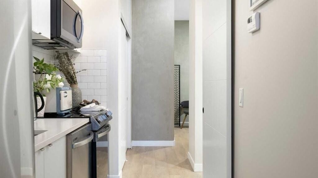 Sleek kitchen area at MaisonGlow in Calgary, Alberta, CA with modern appliances and minimalist decor.