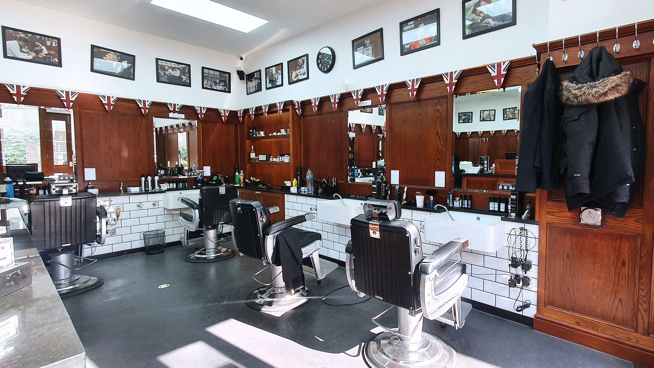 Interior of Pall Mall Barbers Paddington in London, England, GB, featuring sleek chairs and classic decor.