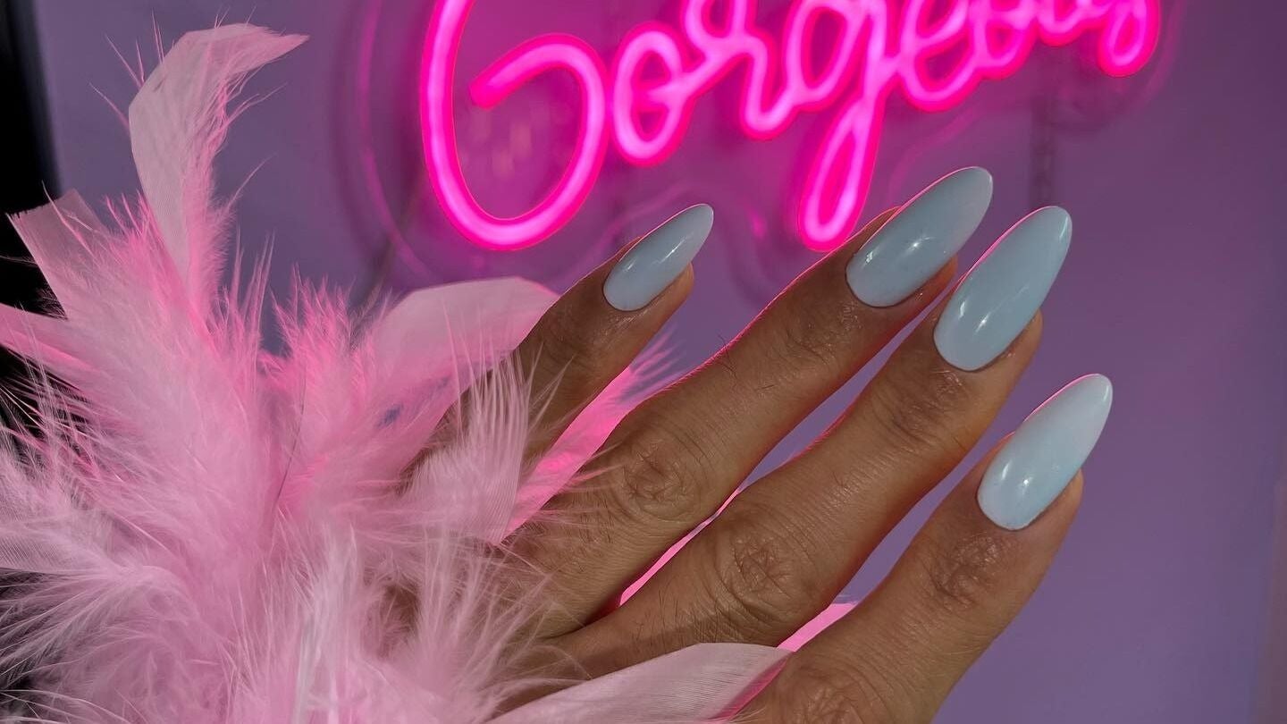 Elegant nail art at Russian Manicure. Awesome Nail Studio, New York, US, with pink neon sign.