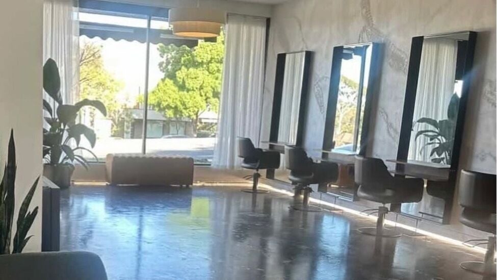 Elegant salon interior at Coiffure in Melbourne, Victoria, AU with modern mirrors and seating.