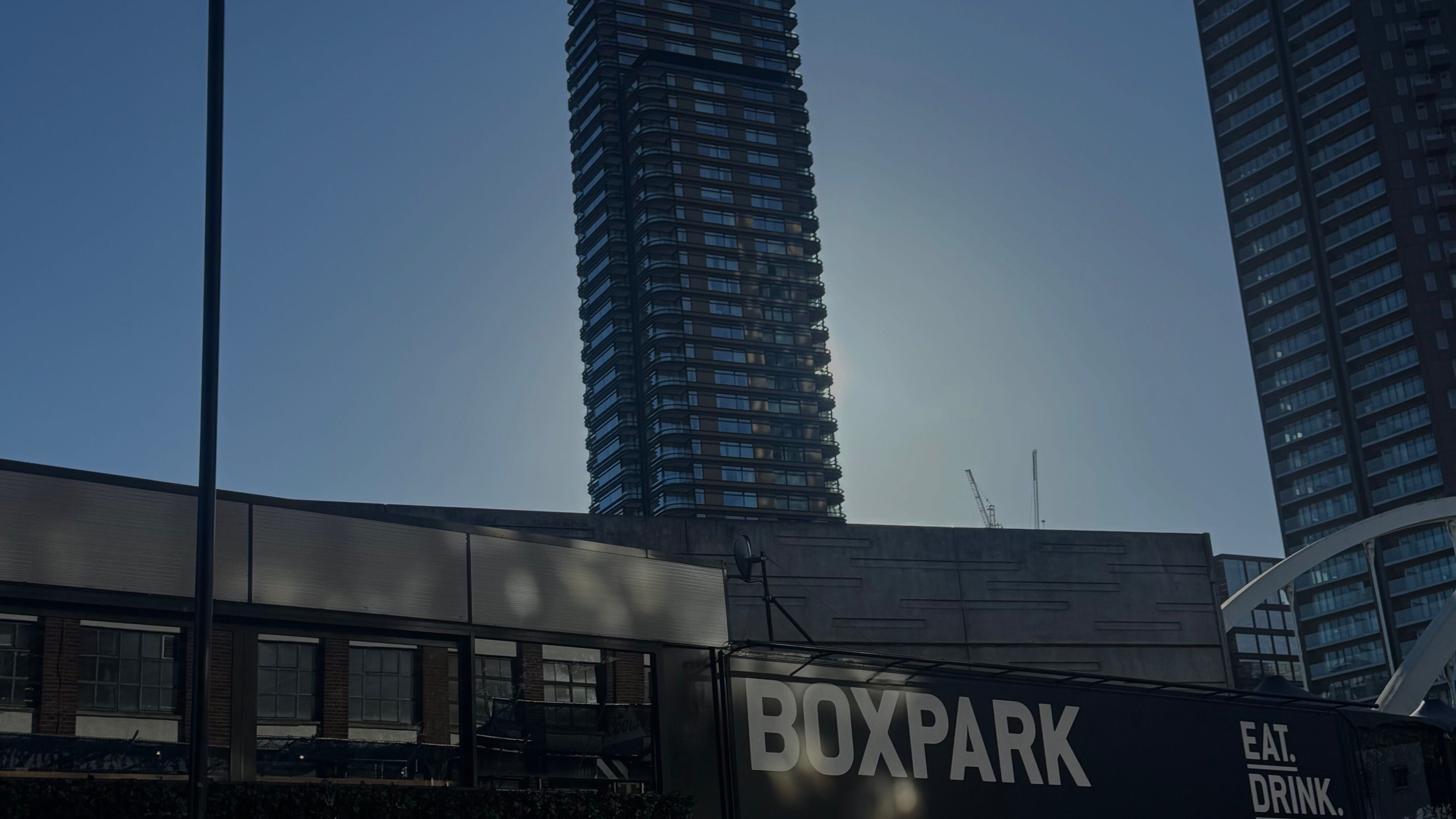 Skyline near MOAI BARBER STUDIO SHOREDITCH in London, England, GB. Tall buildings surround the iconic Boxpark.