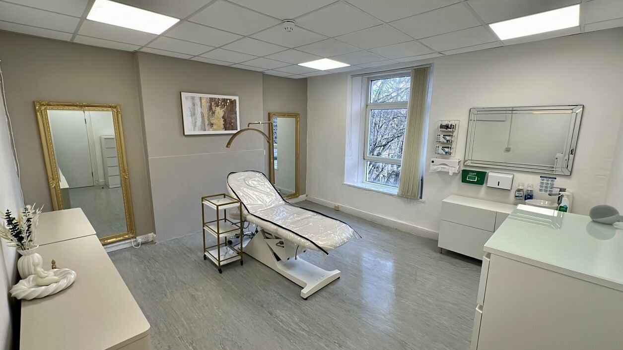 Elegant treatment room at Luxe Beautè, Cardiff, Wales, GB, featuring modern decor and comfortable seating.