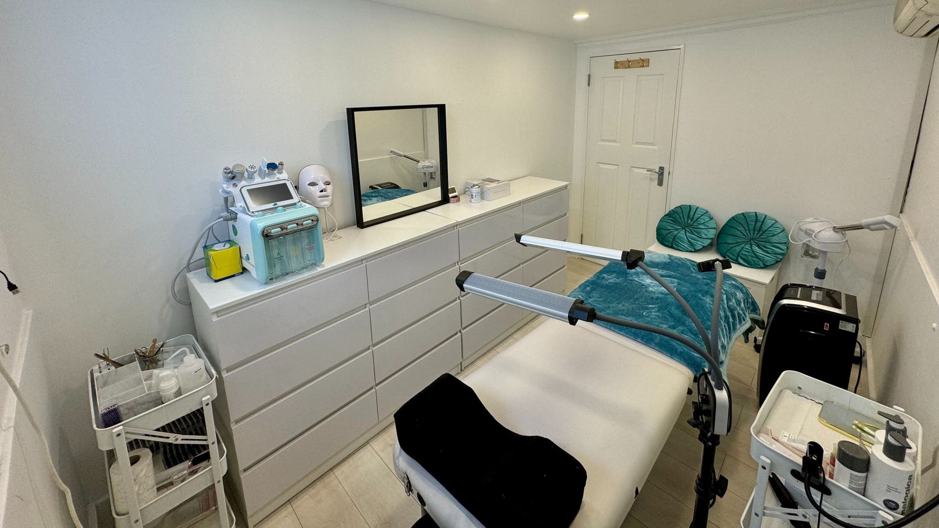Modern treatment room at Victoria Beauty and Aesthetics, London, England, GB, with equipment and relaxing decor.