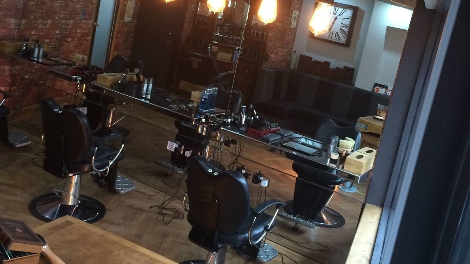 Interior view of Fleet's Barber Shop in Beccles, England, GB, featuring modern barber chairs and styling stations.