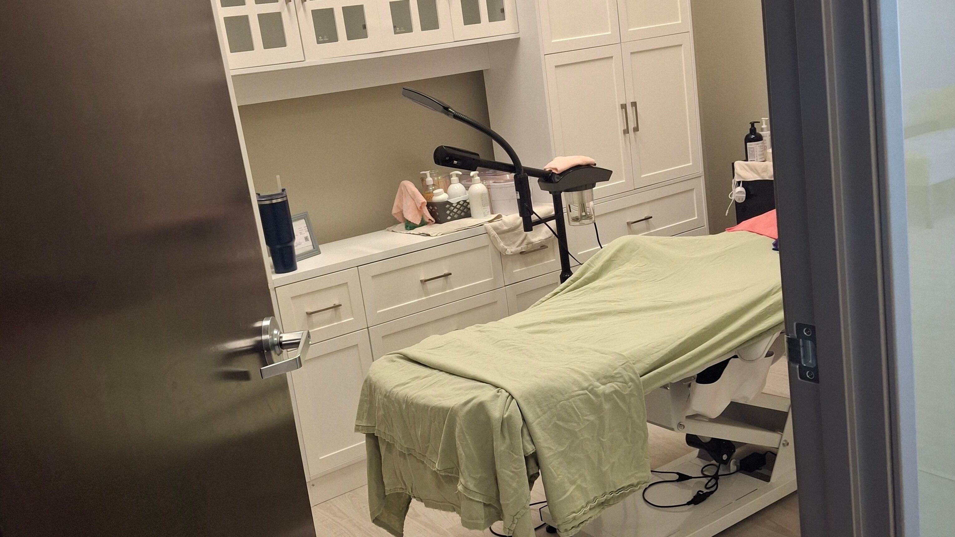 Cozy treatment room at Beautiful Rose Spa, Avondale, Arizona, US. Modern design with soft green linens.