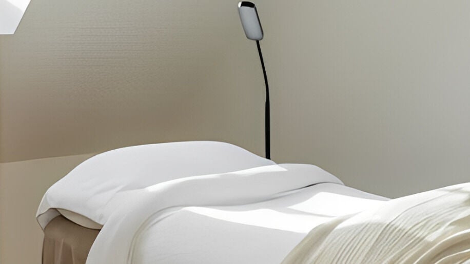Calming treatment room at Kure Skin Clinic, Hampstead Norreys, England, GB. Cozy bed with soft lighting.