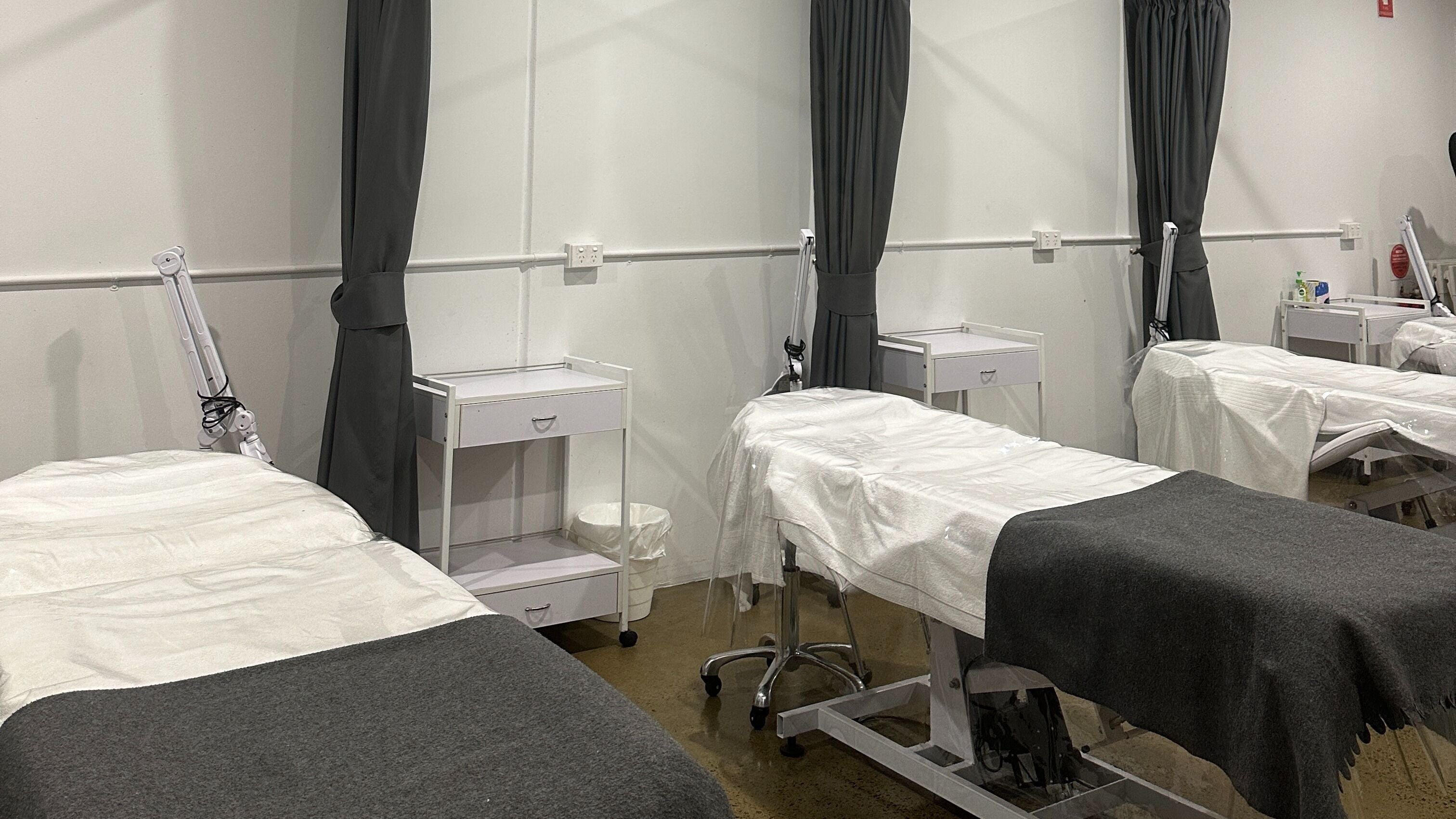 Treatment beds at CCBT Dermal Student Salon, Melbourne, Victoria, AU, ready for relaxation and beauty treatments.