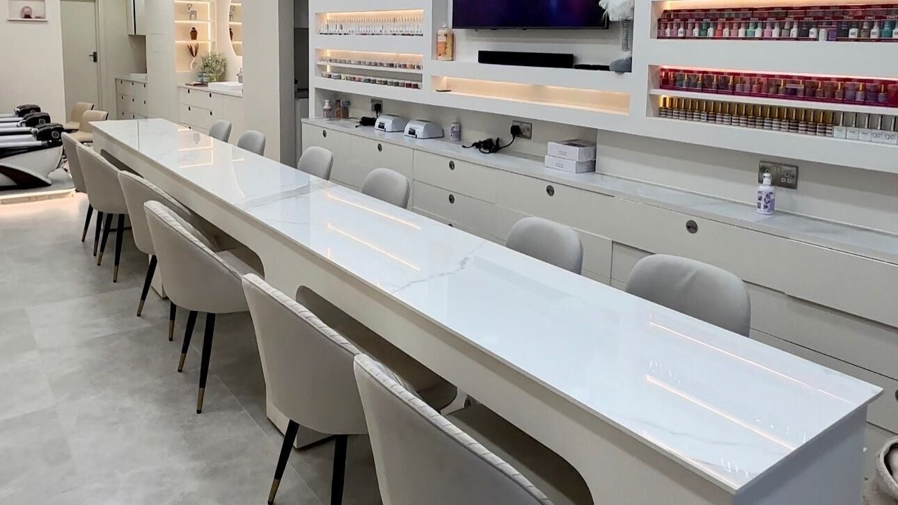 Sleek white nail stations at DP Nail Spa, London, England, GB, showcasing a modern and inviting atmosphere.