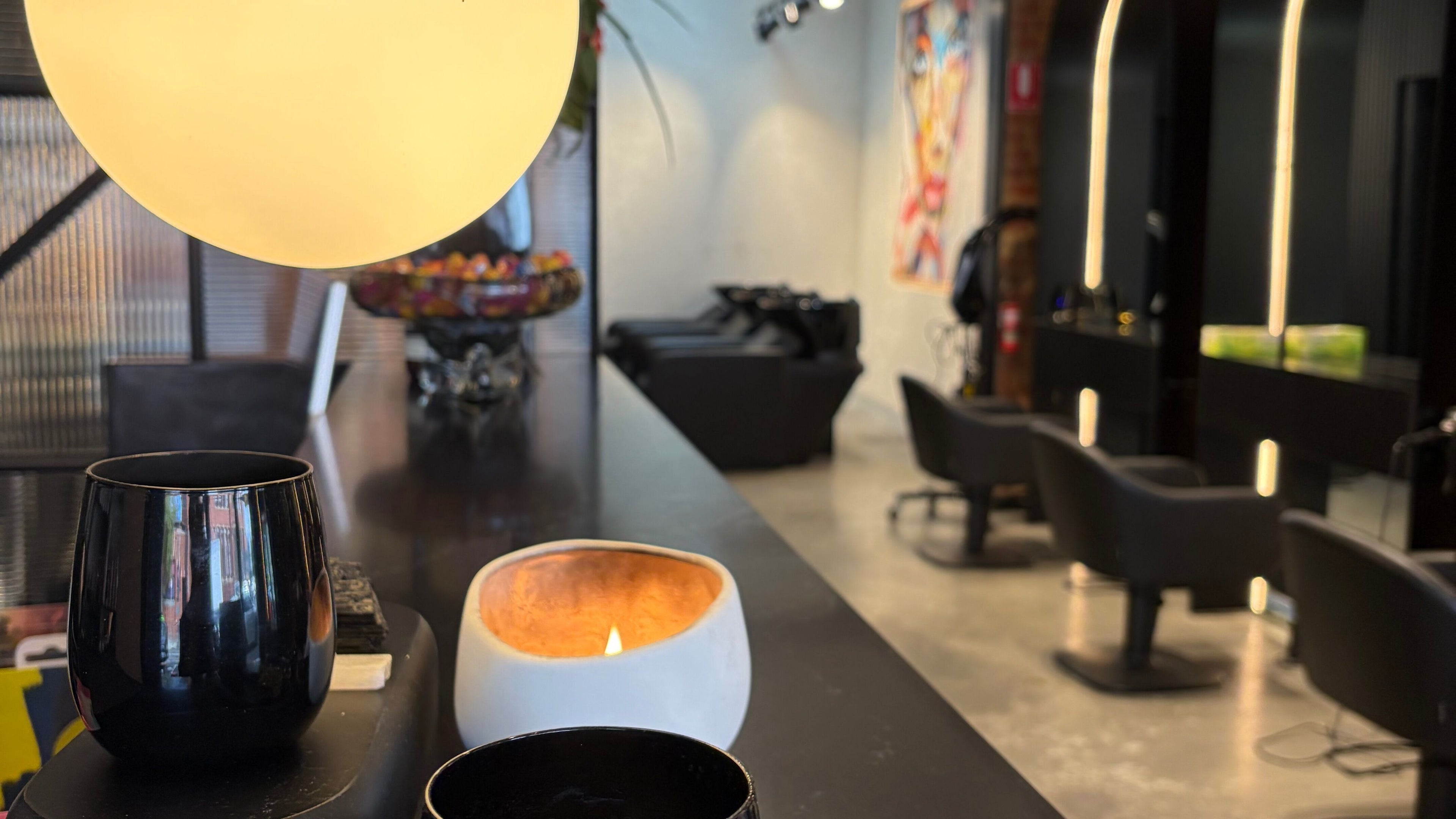 Warm, stylish salon interior at Eran Benn, Melbourne, Victoria, AU, featuring sleek chairs and ambient lighting.