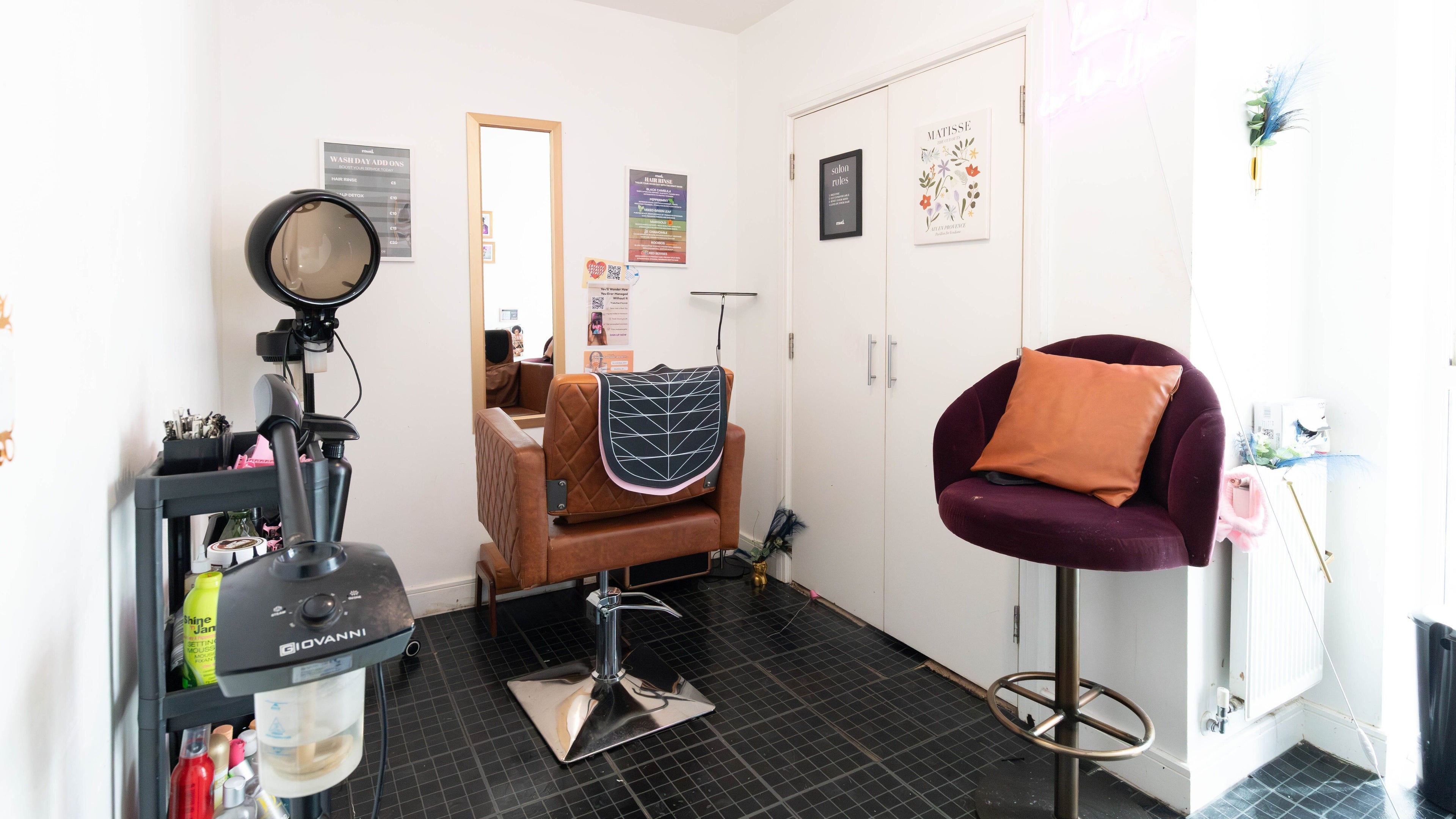 Modern salon setup inside My Wash Days, London, England, GB with stylish seating and hair equipment.
