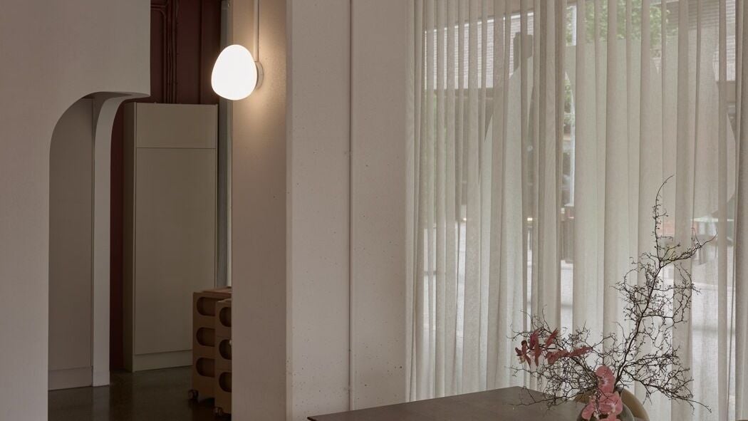Elegant minimalist interior of Maed By Studio in Melbourne, Victoria, AU featuring ambient lighting and floral decor.