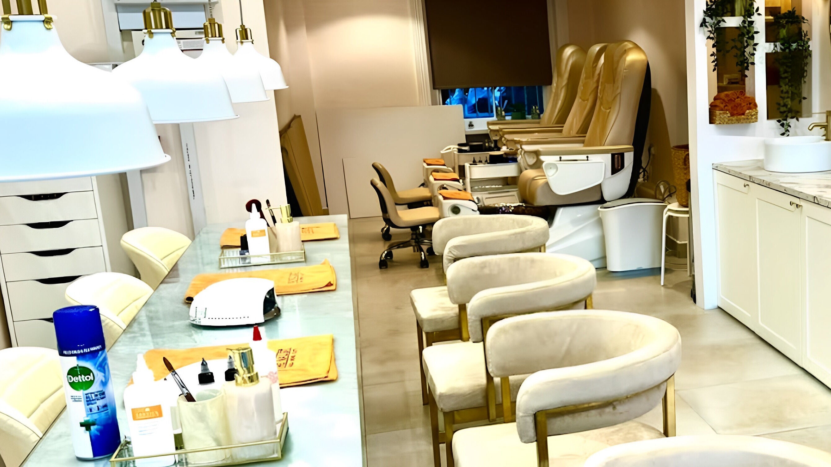 Interior of The Nailist in London, England, GB showcasing luxurious beige chairs and modern nail stations.