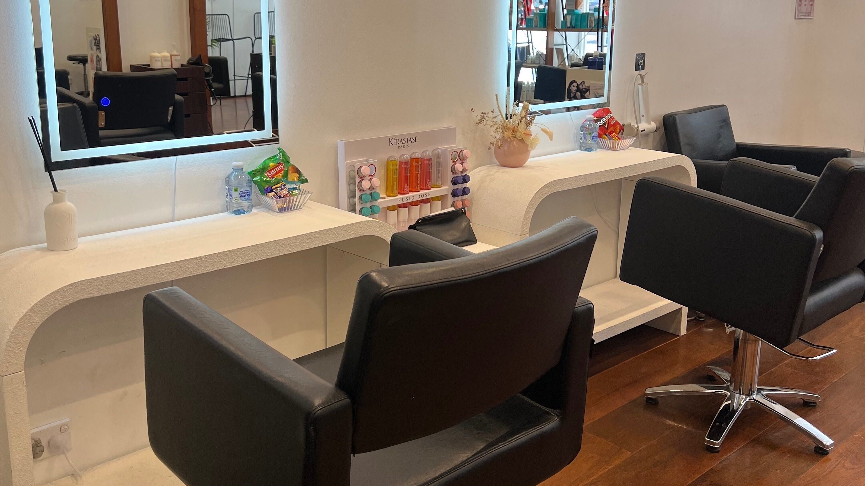 Modern salon chairs at Q Hair Melbourne, Victoria, AU. Sleek design with professional styling stations.