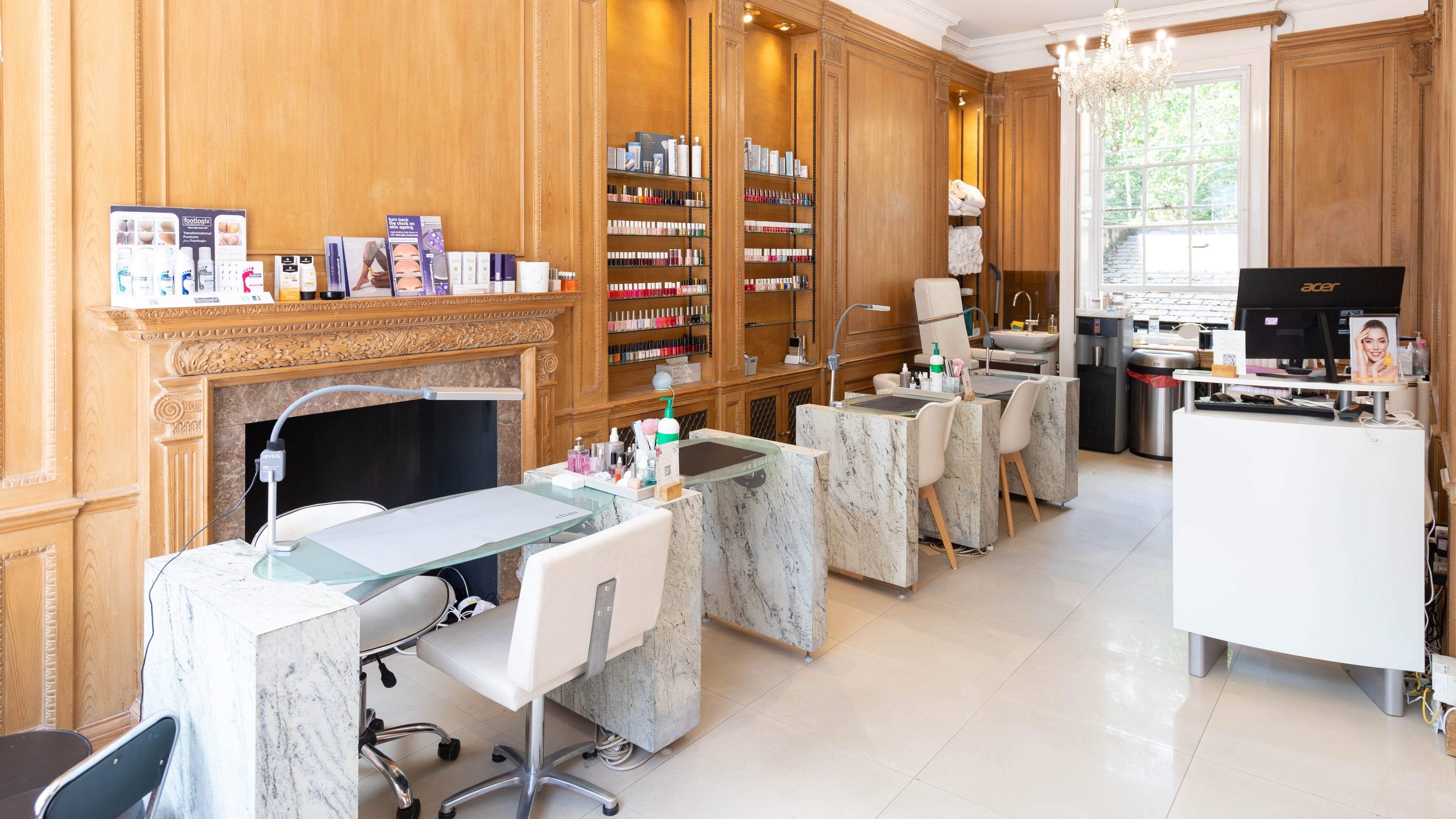 Spacious, luxurious nail salon interior at Nailstation, London, England, GB with elegant seating and nail stations.