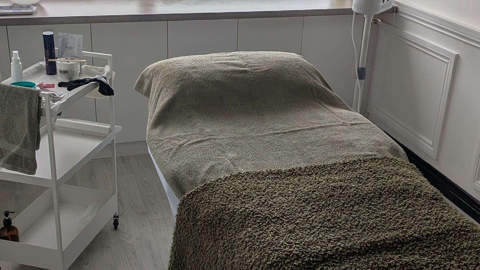 Cozily prepared treatment bed at Graceful Skin & Wellness, Paisley, Scotland, GB.