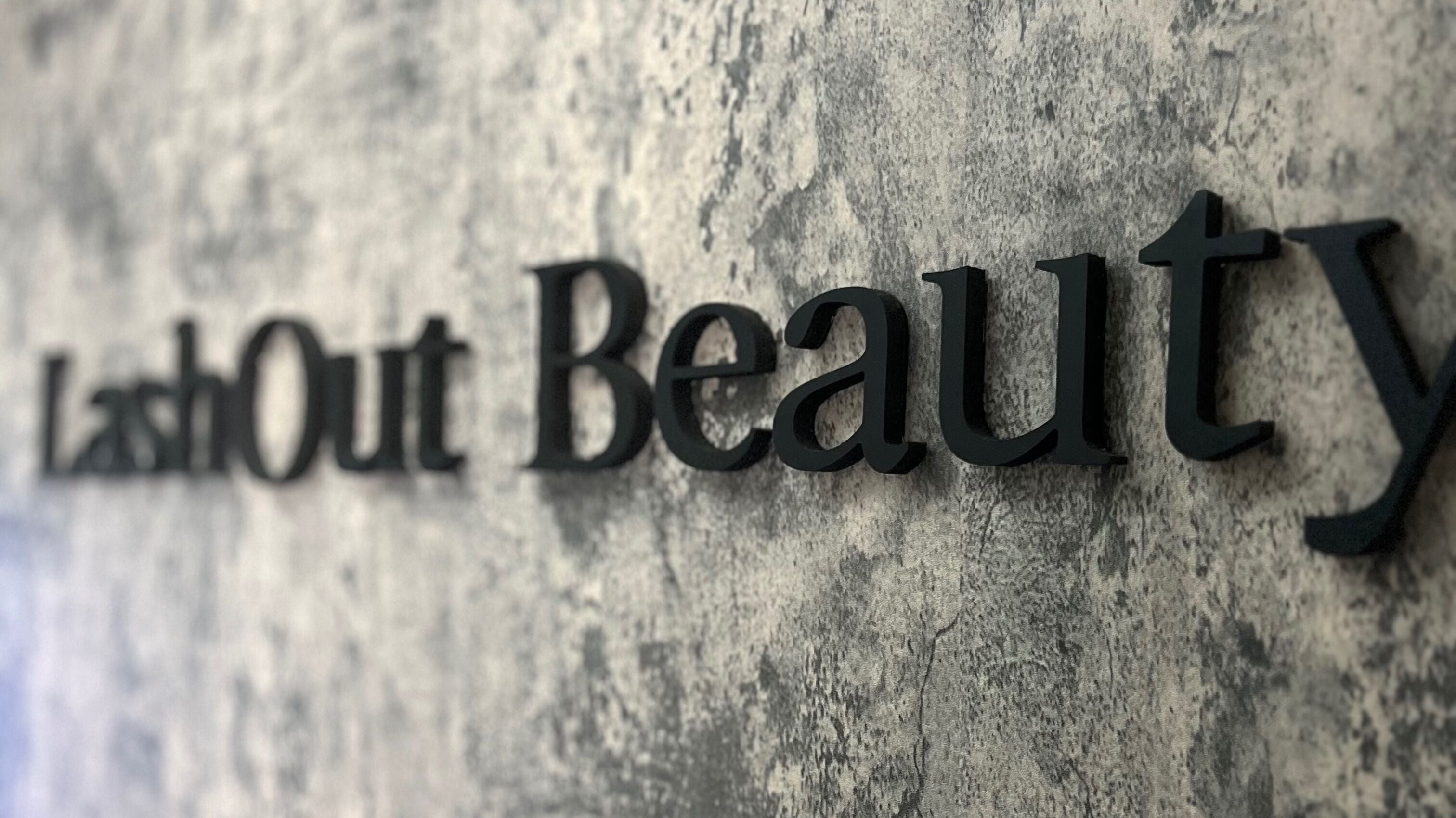 LashOut Beauty sign on textured wall at Houston, Texas, US.