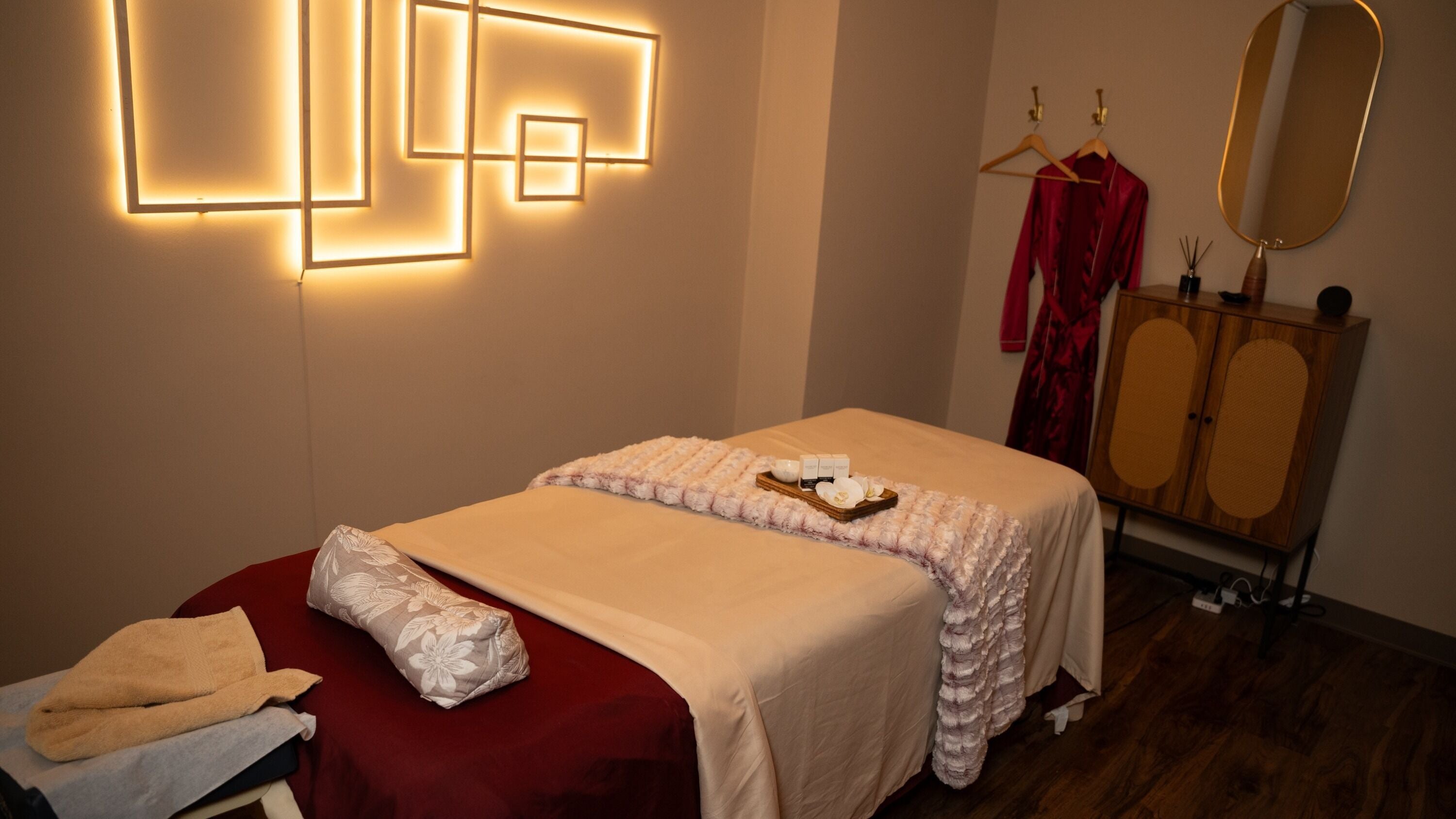Relaxing treatment room at Luxsa Thai Spa, New York, New York, US, with ambient lighting and cozy decor.