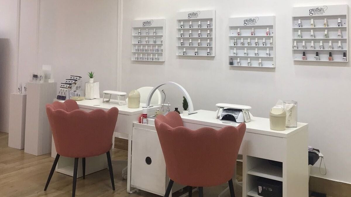 Relaxing nail spa setting at Reef Beauty Lounge & Spa, Abu Dhabi, Abu Dhabi, AE with chic coral chairs.