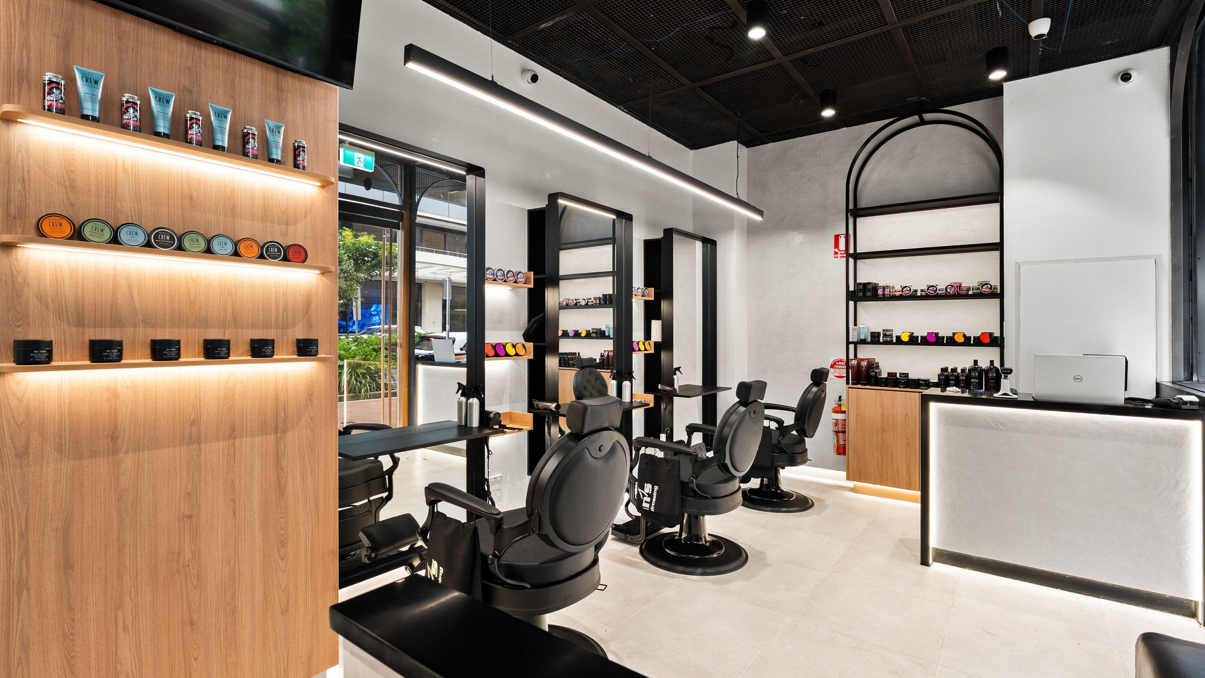 Modern interior of Hair At Eveleigh in Eveleigh, New South Wales, AU featuring sleek salon chairs and products.
