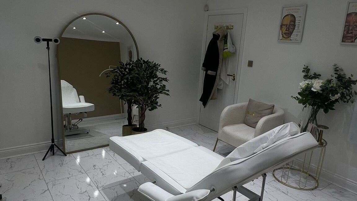 Stylish treatment room at Cove Skin Clinic, Hornchurch, England, GB, featuring a chic chair and mirror.