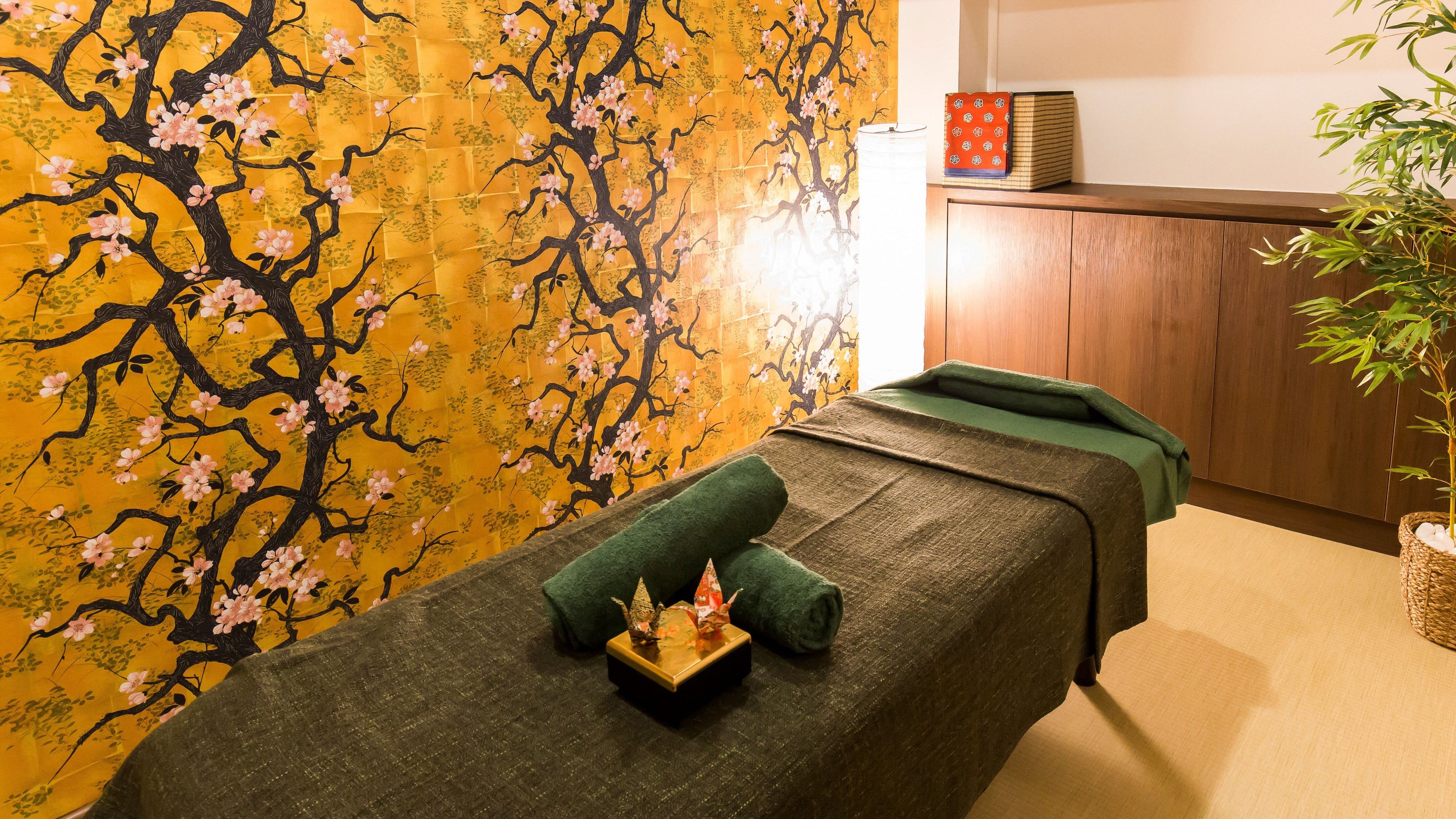 Serene massage room with cherry blossom decor at Atelier Kogao Clarke Quay, Singapore, Singapore, SG.