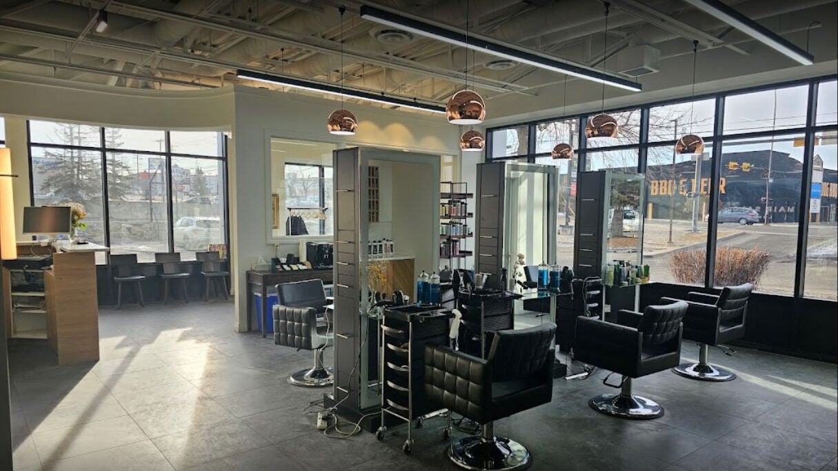 Spacious interior of London Hair Salon 58th Avenue in Calgary, Alberta, CA with modern decor and stylist chairs.