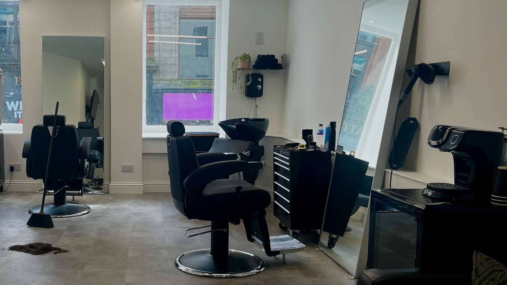 Modern barber chair and mirror at Eleven8 Barber Studio in Glasgow, Scotland, GB.