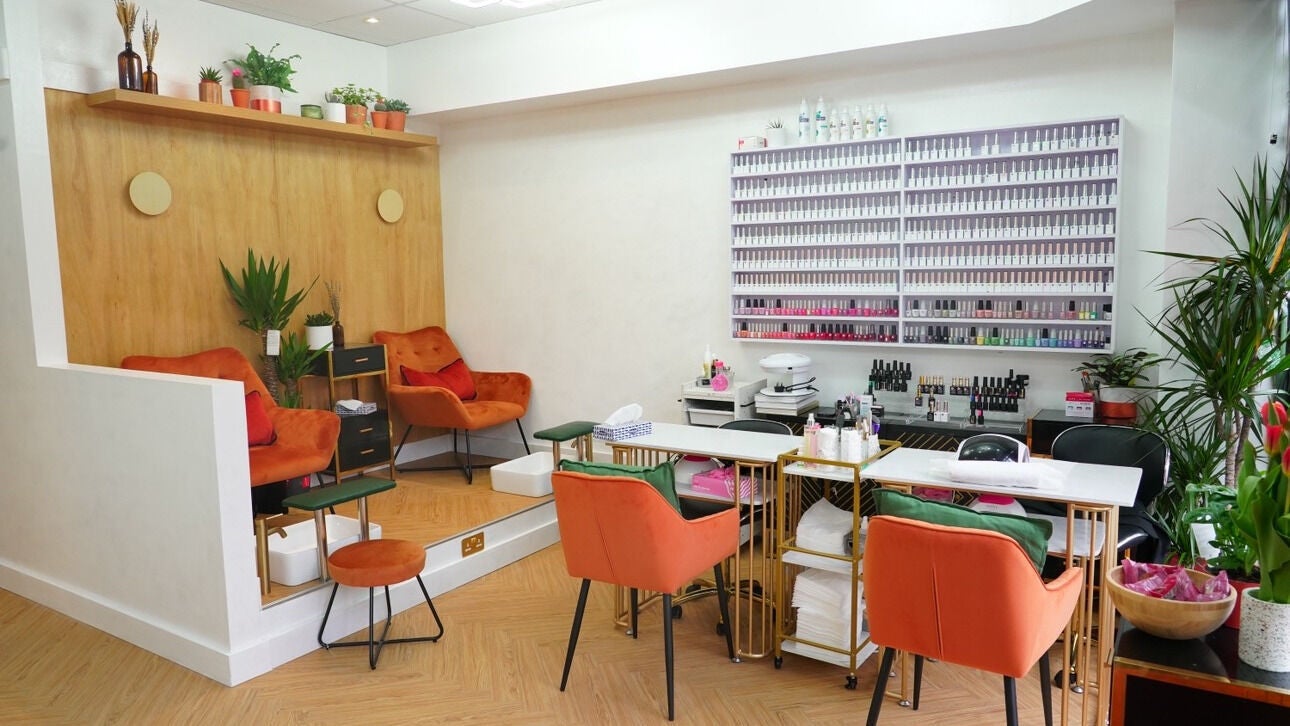 Inviting interior of House of Bloom Hayes in Bromley, England, GB featuring vibrant chairs and manicure station.
