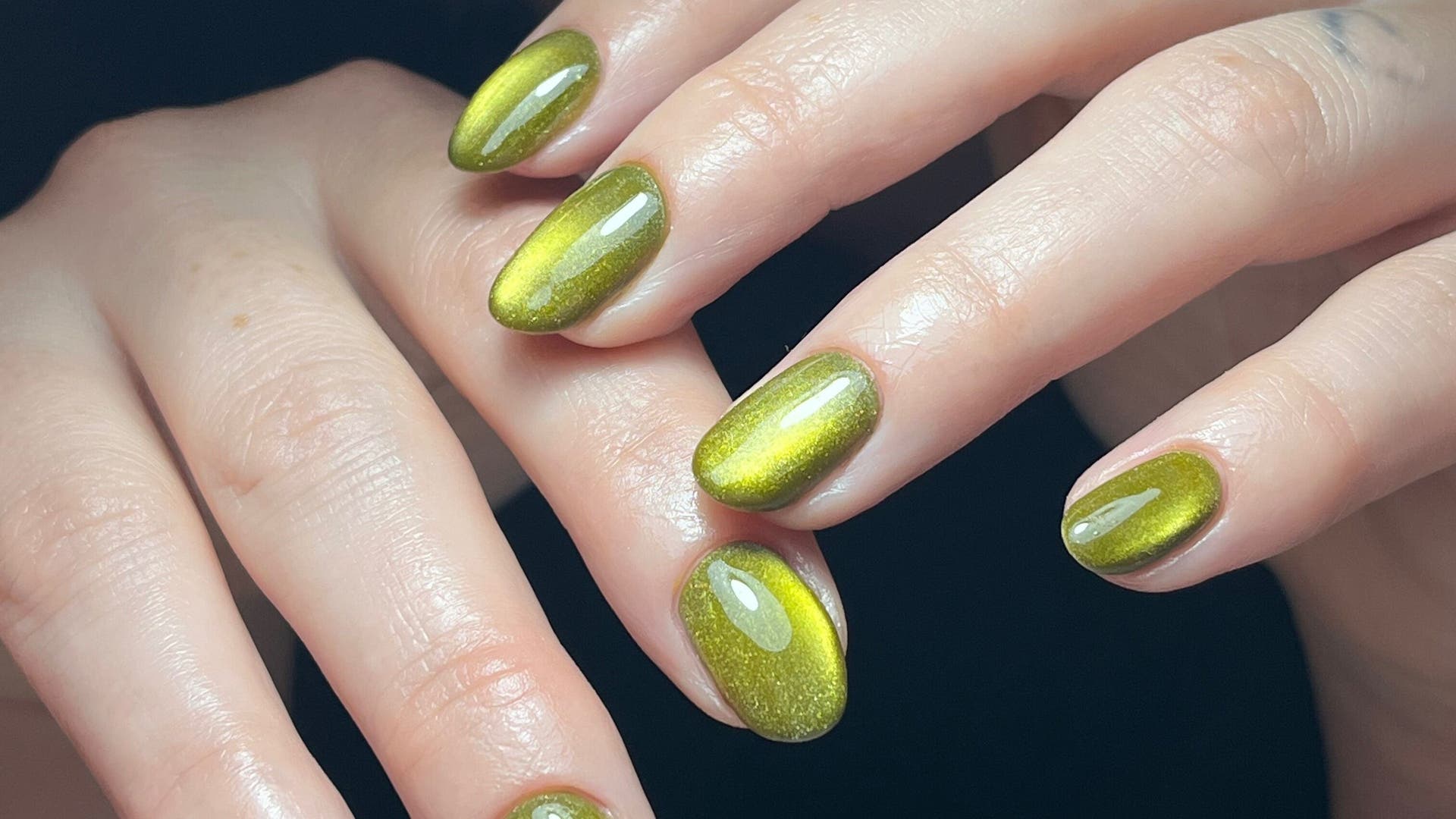 Stylish emerald green nails at Claws By Clayre, Glasgow, Scotland, GB, showcasing expert manicure skills.