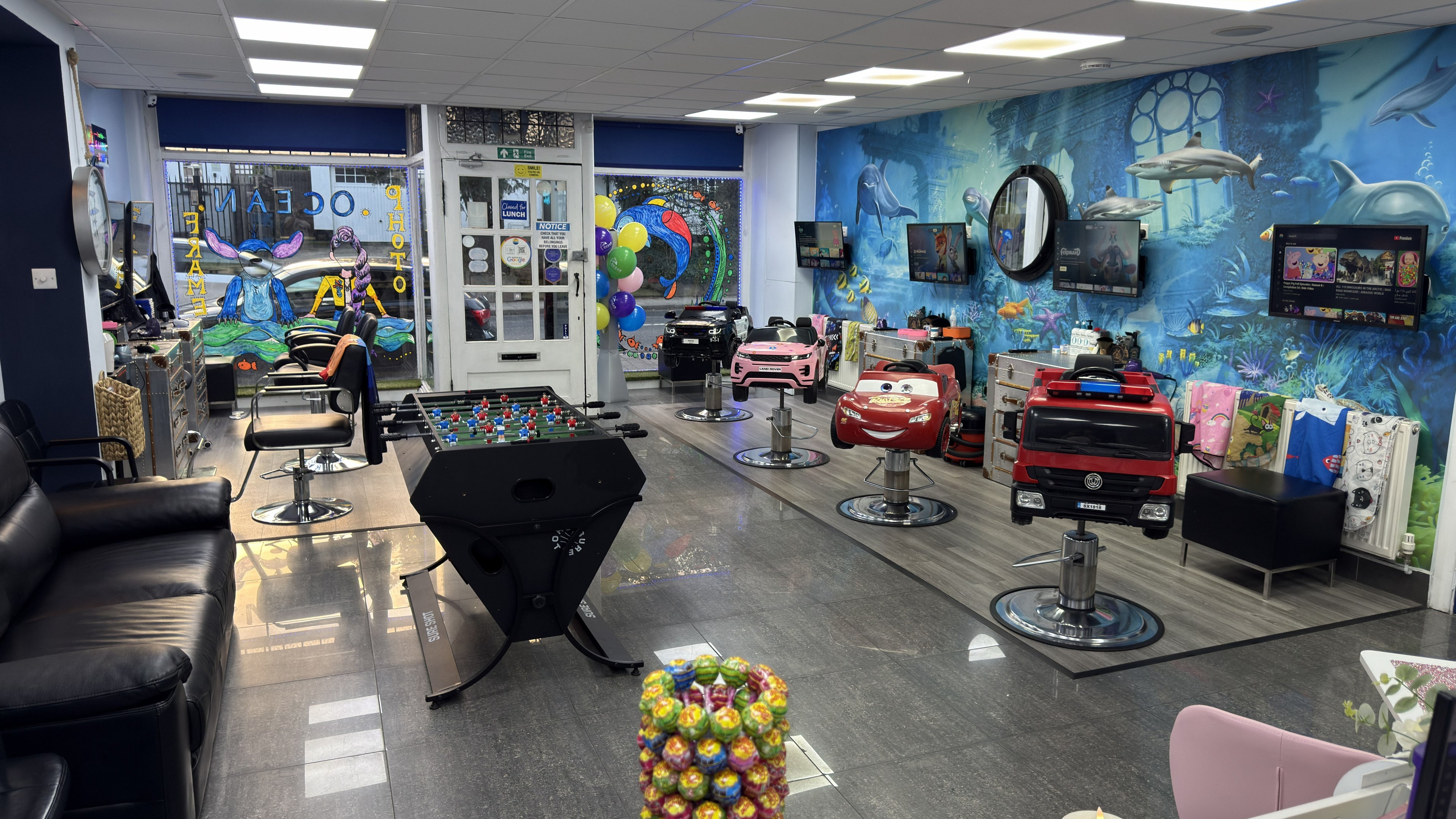 Bright salon interior at Ocean Kids and Family Salon, Radlett, England, GB, featuring playful kids' seating.