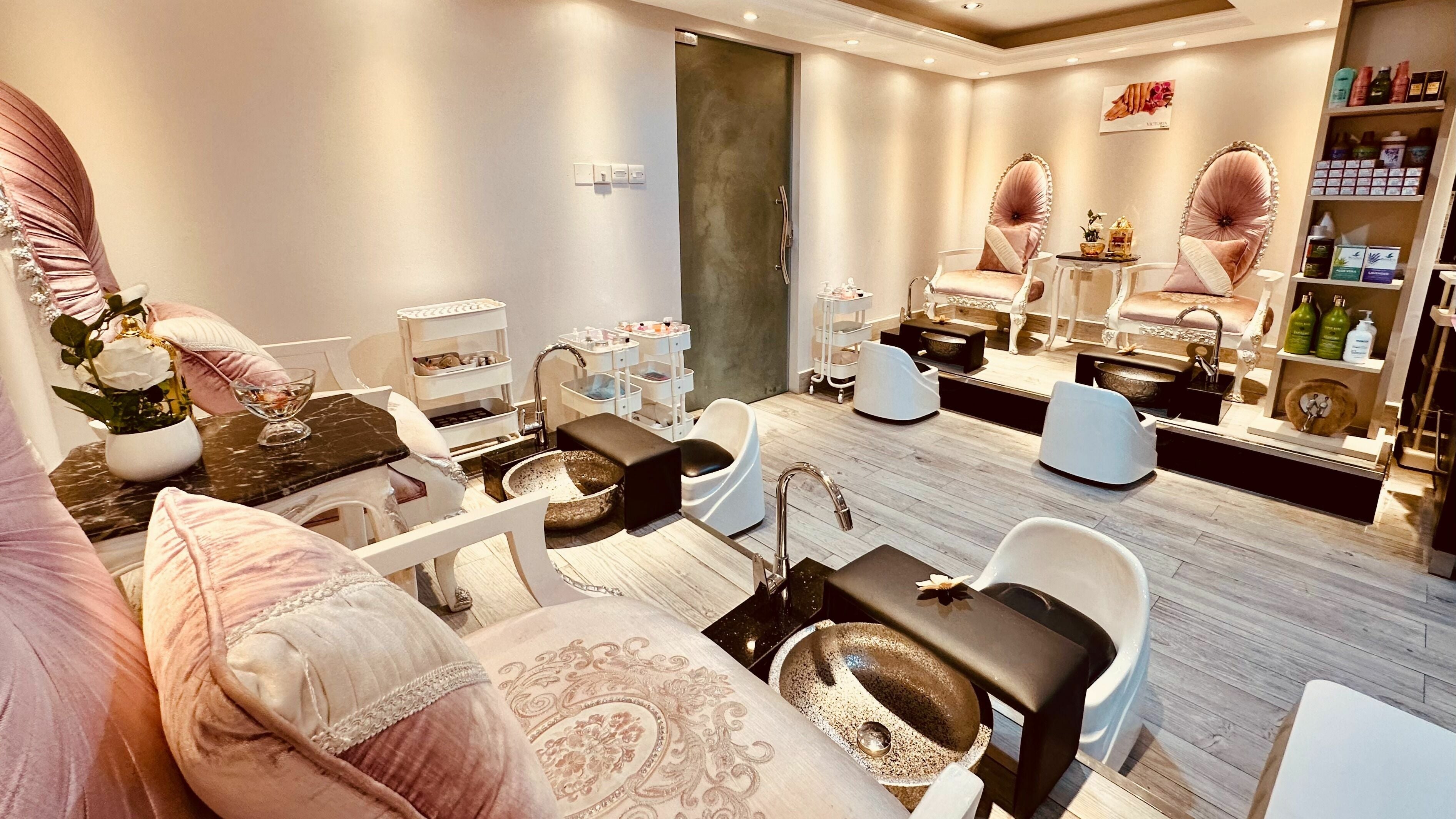Luxurious pedicure stations at Victoria Salon and Spa, Abu Dhabi, AE. Cozy pink chairs create a relaxing ambiance.