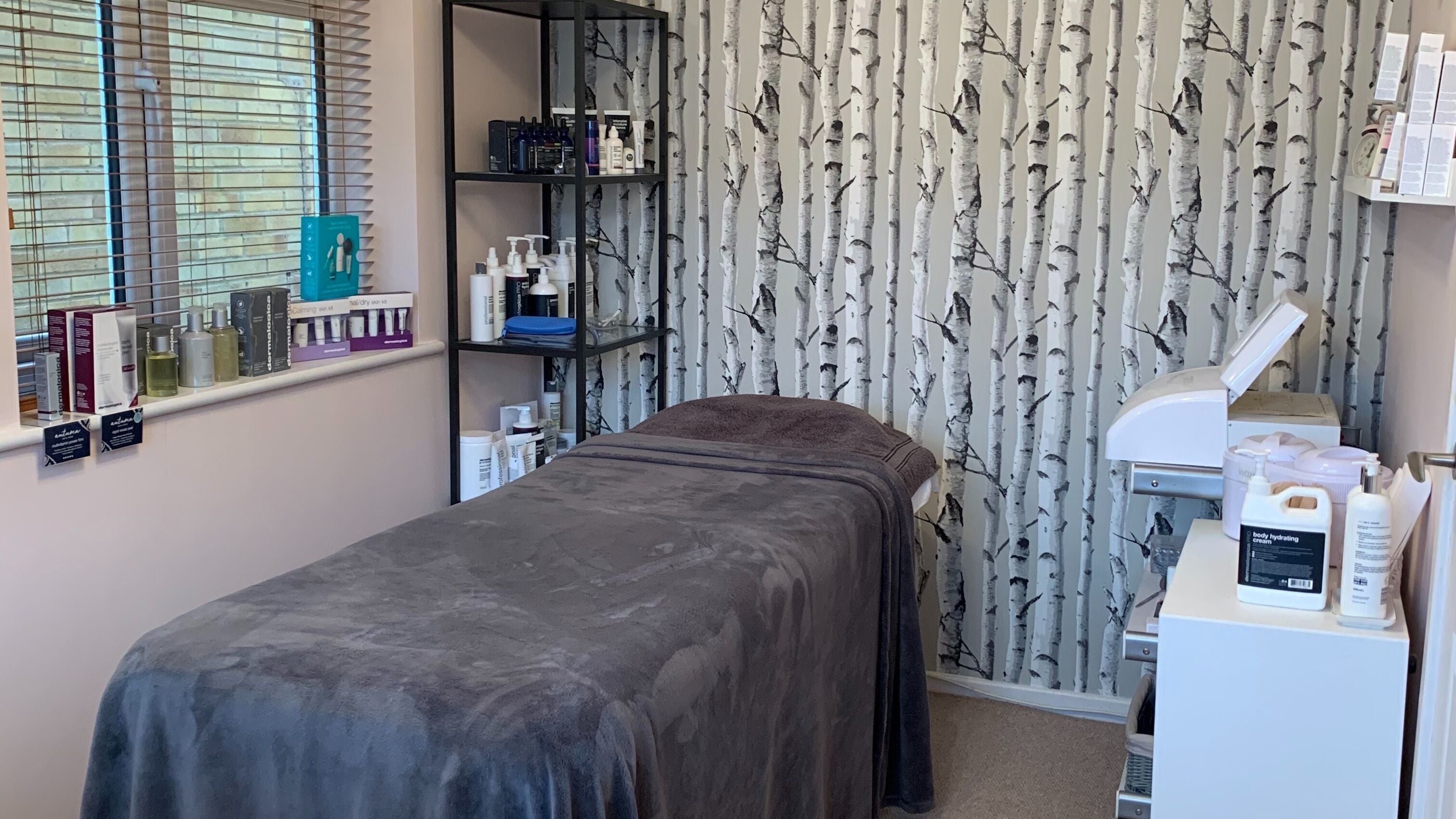 Calming treatment room at Perfect Touch, Wallingford, England, GB, featuring a massage table and products.