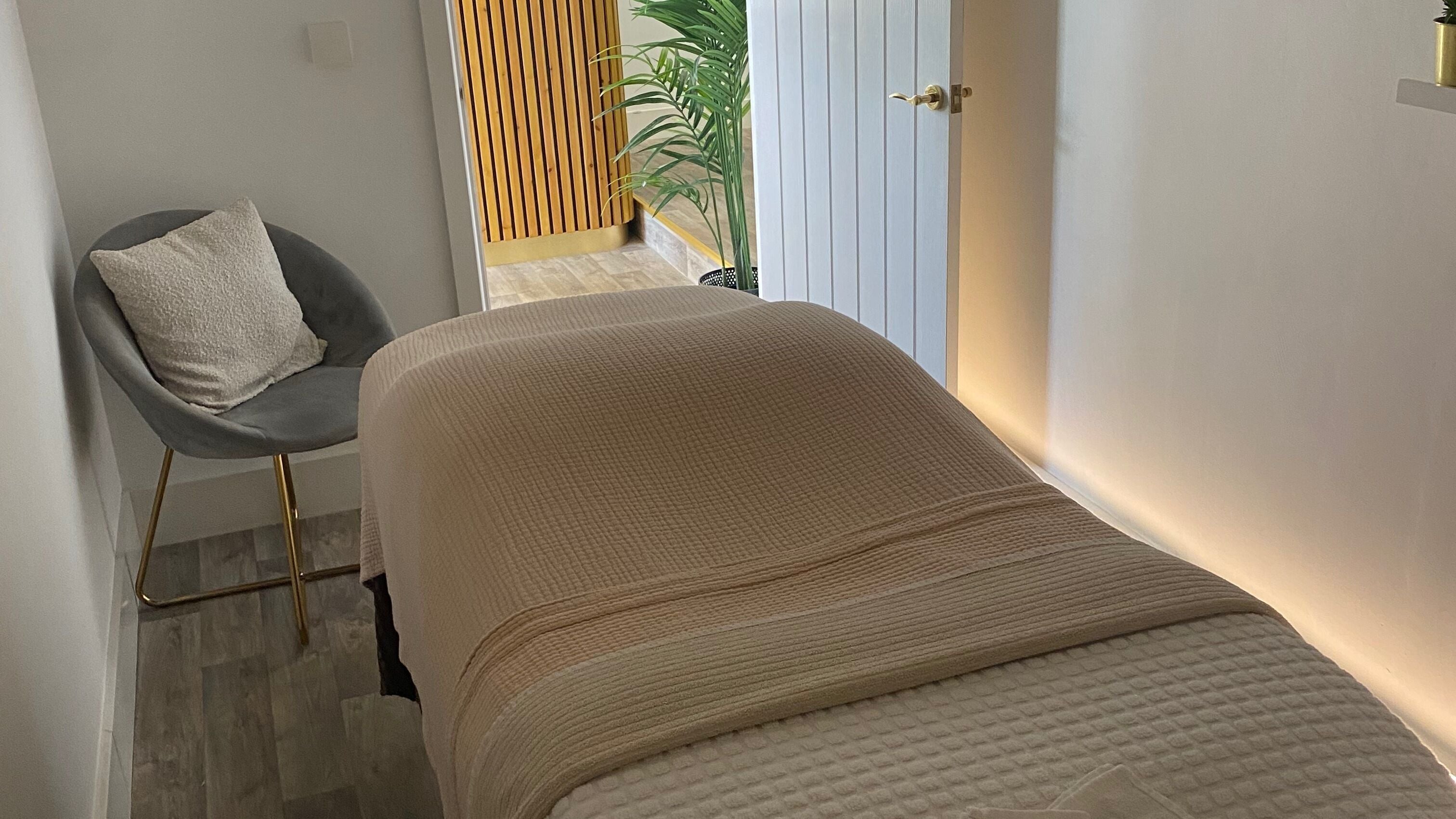 Cozy treatment room at Hunt. Skincare in Eastbourne, England, GB with massage table and soft lighting.