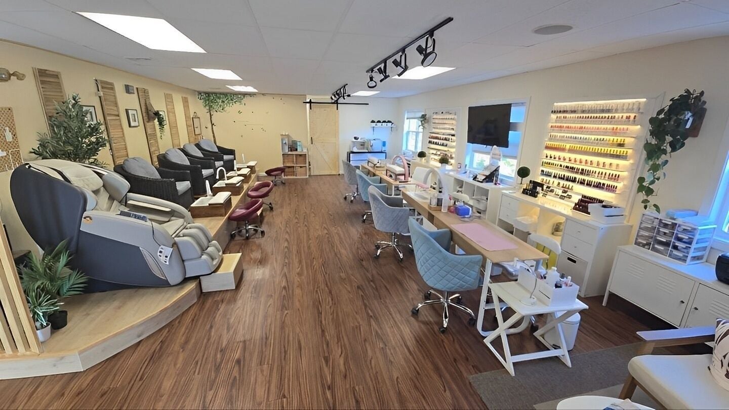 Modern interior of K-Beauty Nail & Spa in Maynard, Massachusetts, US, showcasing sleek nail stations and seating.
