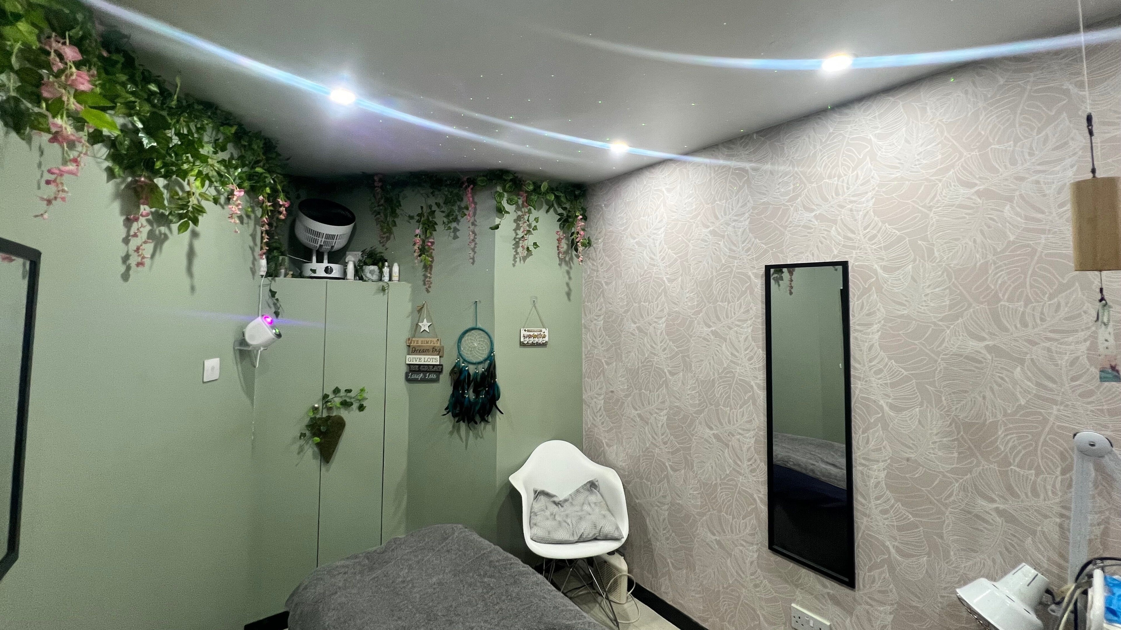 Serene room at Awesome Hugs Beauty & Wellness, Glasgow, with plants and soft lighting.