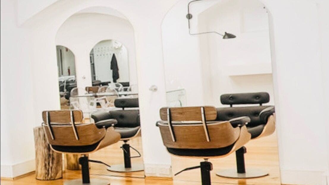 Modern salon interior at Hair by Clement, Sydney, New South Wales, AU, featuring stylish chairs and sleek mirrors.