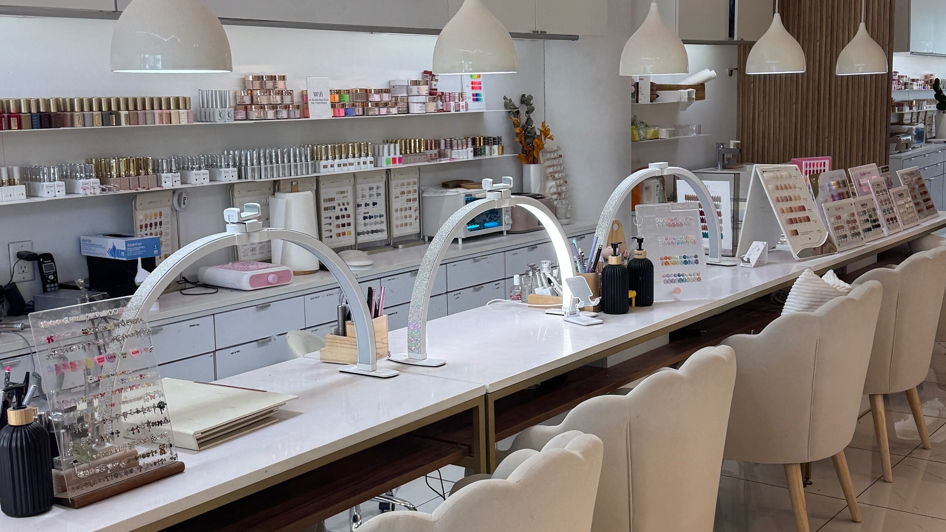 Modern nail bar at Rêverie Nails Lounge in Burnaby, British Columbia, CA, featuring elegant decor and nail polish display.