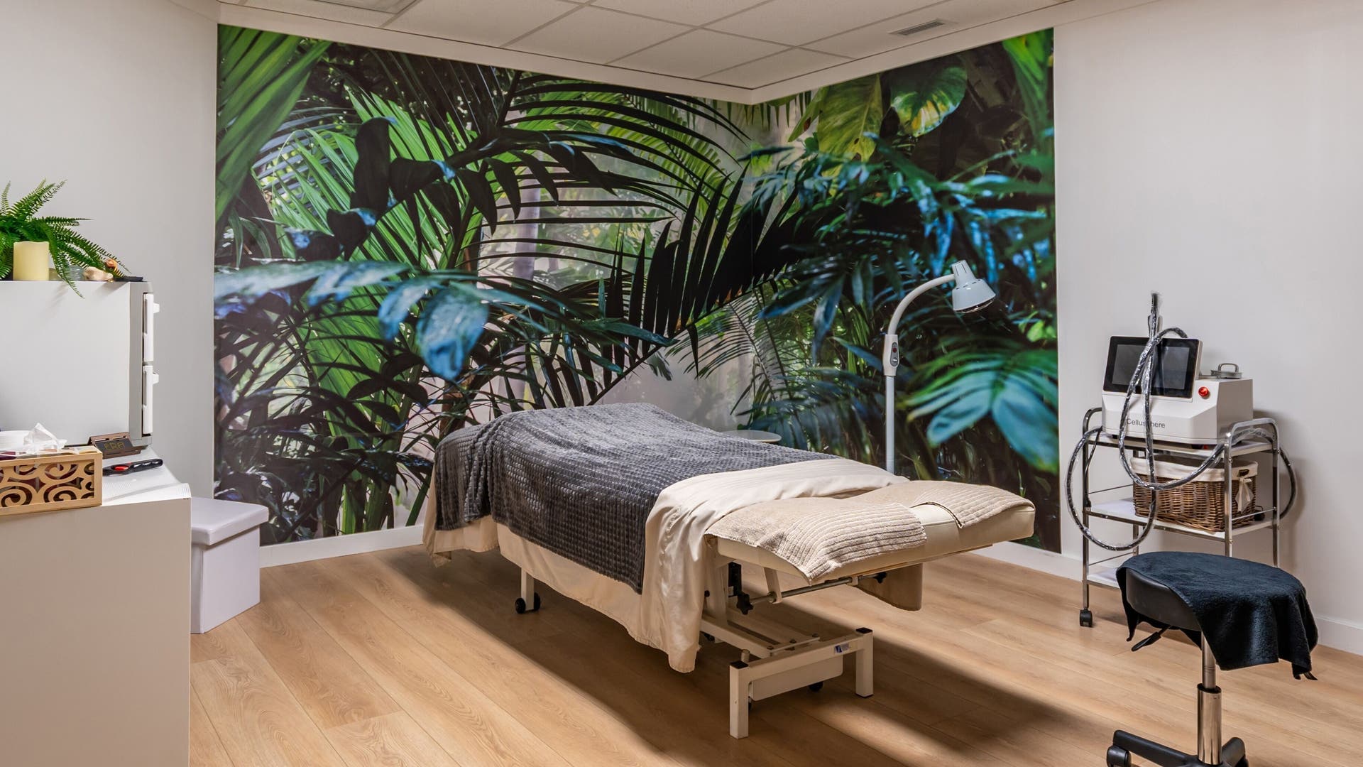 Tranquil massage room with tropical mural at ERA Massage & Beauty in Calgary, Alberta, CA.