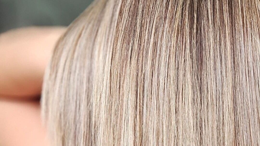 Close-up of smooth blonde hair at CC Hair, London, England, GB, highlighting expert balayage technique.